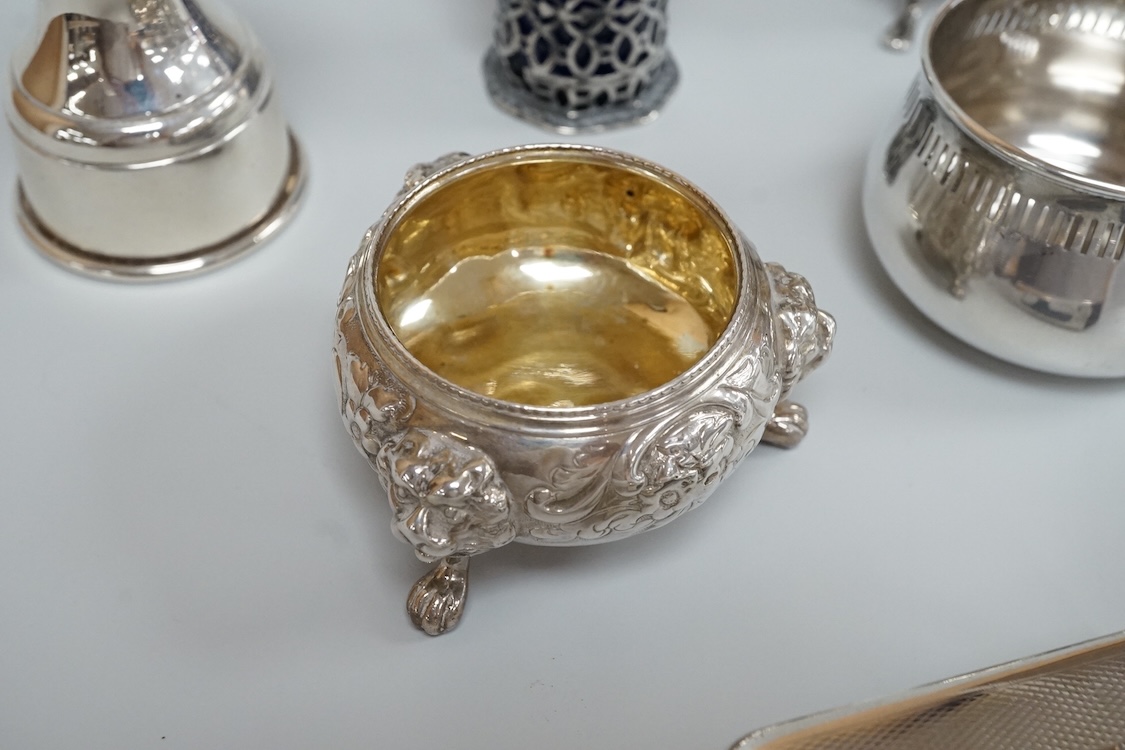 Four assorted silver condiments including a Victorian bun salt and a late Victorian pepper mill, together with a small silver bowl, a silver matchbox sleeve and a small silver two handled cup.